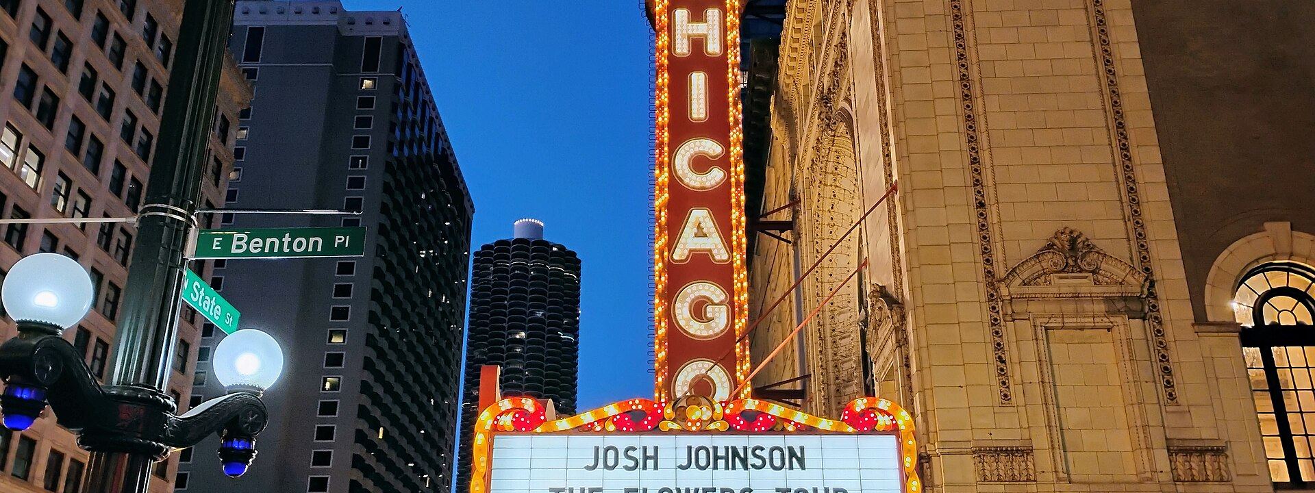 The Chicago Theatre marquee lit at dusk on State Street.